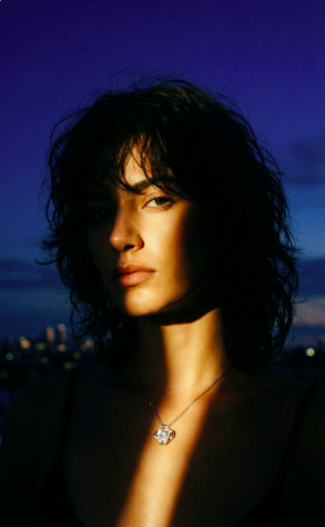 Woman wearing an Eternal Love pendant necklace in an elegant evening setting