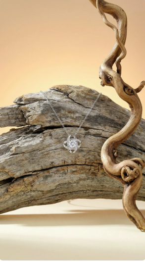 Eternal Love pendant necklace displayed on natural driftwood background