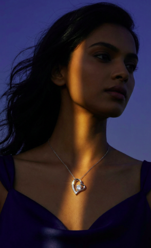 Woman wearing a Forever Love heart pendant necklace against a dramatic purple background
