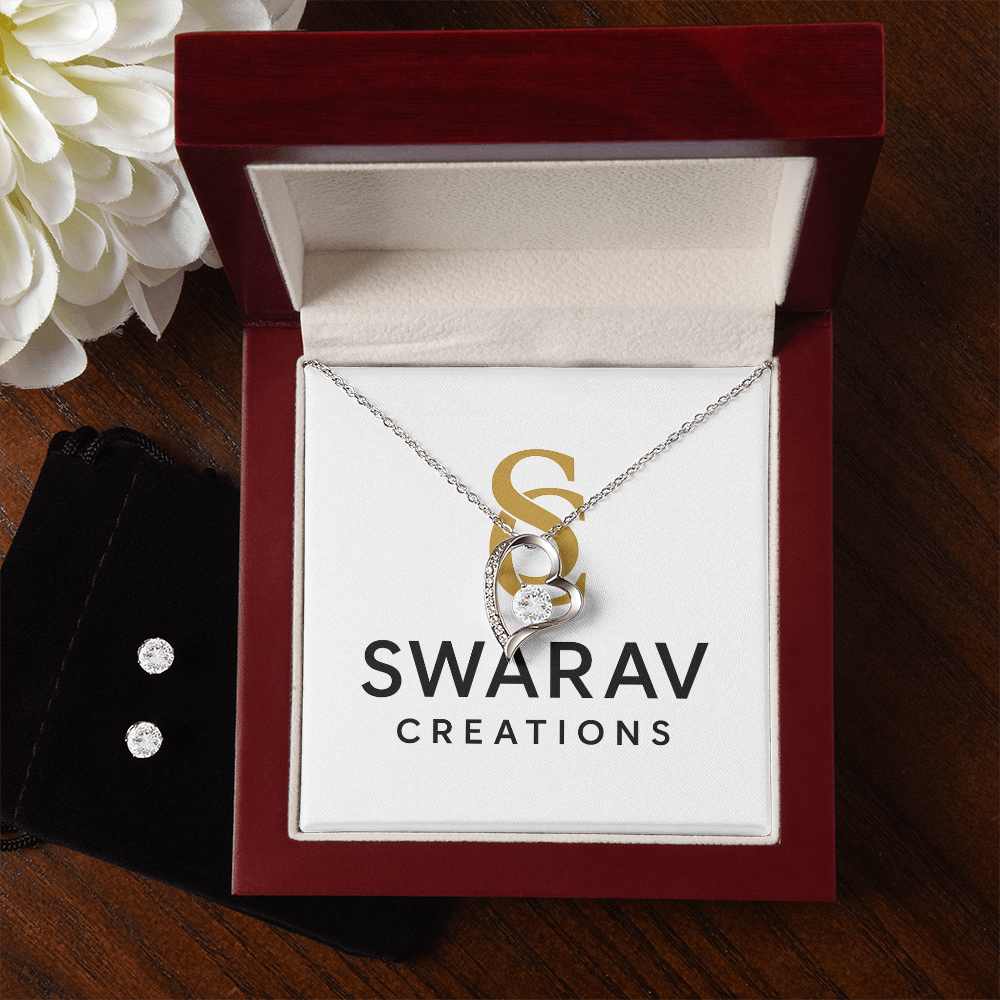 Open luxury jewelry box showcasing forever love necklace and matching earrings in 14k white gold